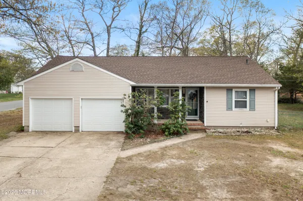 a view of a house with a yard and garage