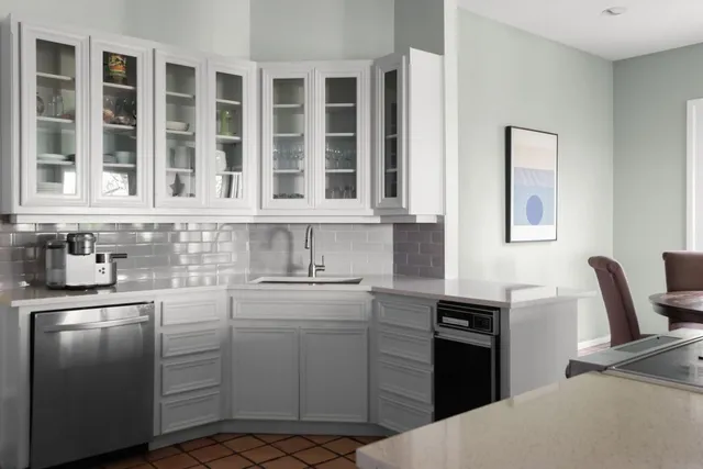a kitchen with stainless steel appliances granite countertop a stove a sink dishwasher and a microwave oven