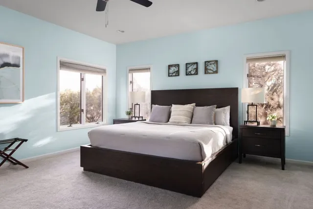 a spacious bedroom with a bed and a window