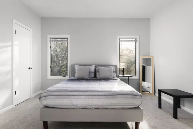 a spacious bedroom with a bed and a window