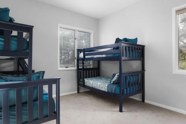 a bedroom with two bunk beds and a window