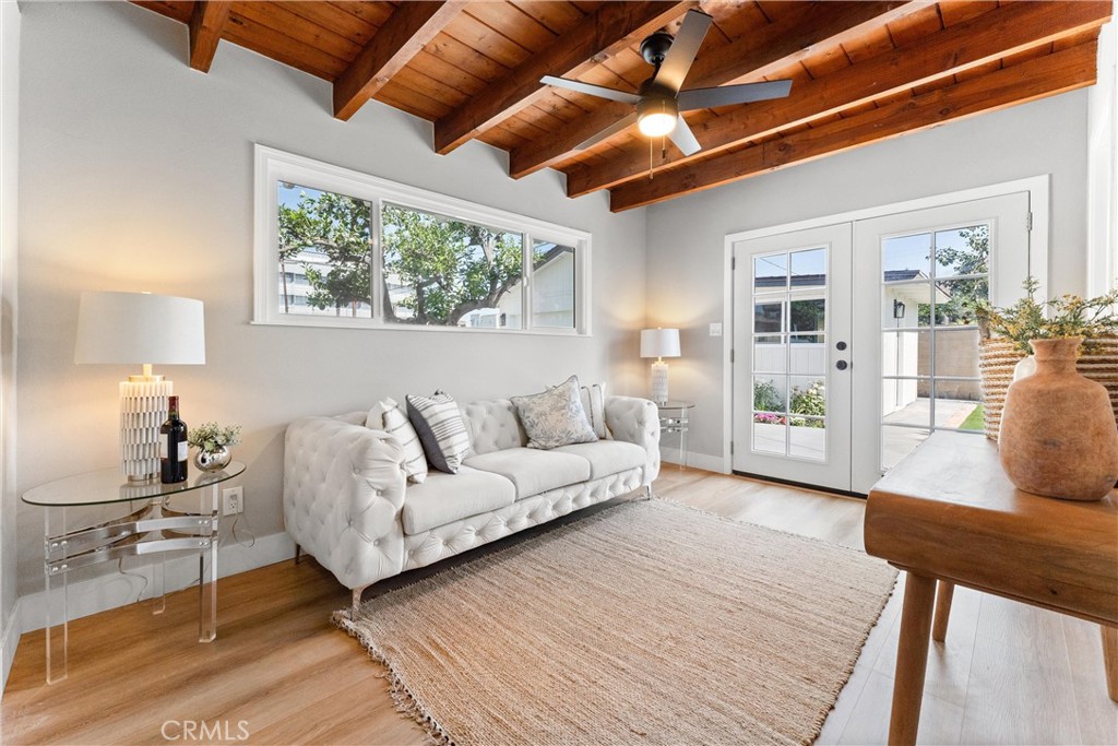 8039 4th Street Downey, CA 90241 - Photo 12 of 26 a living room with furniture and a large window