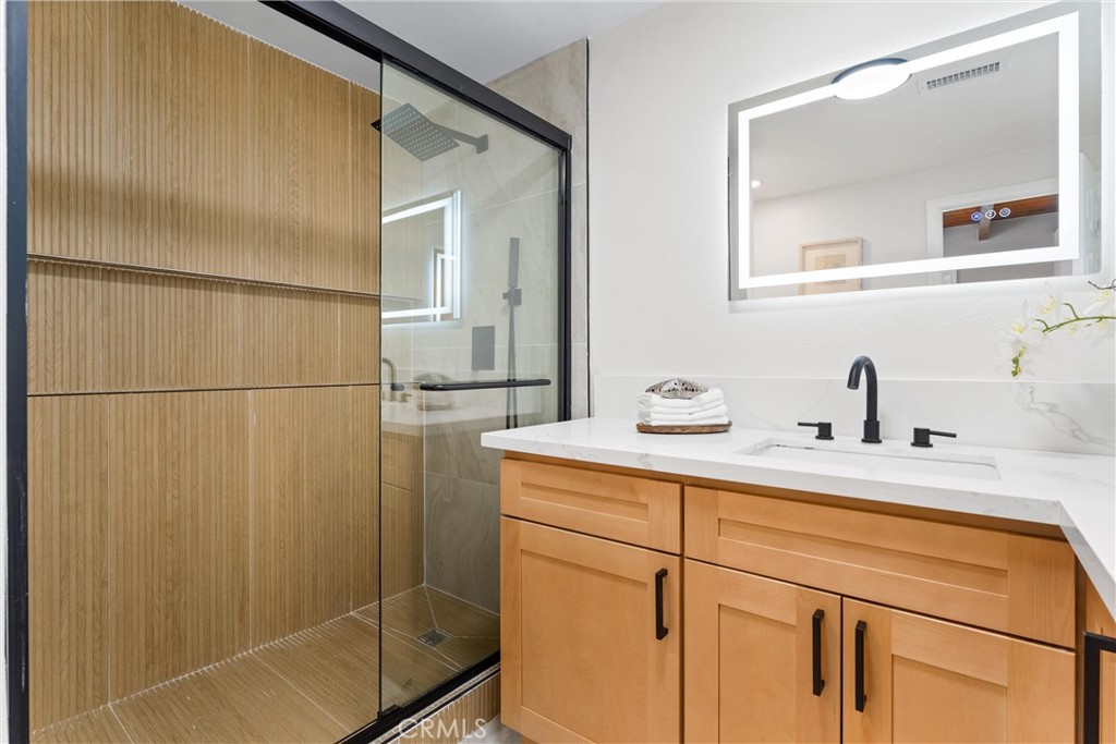 8039 4th Street Downey, CA 90241 - Photo 14 of 26 a bathroom with a sink and mirror