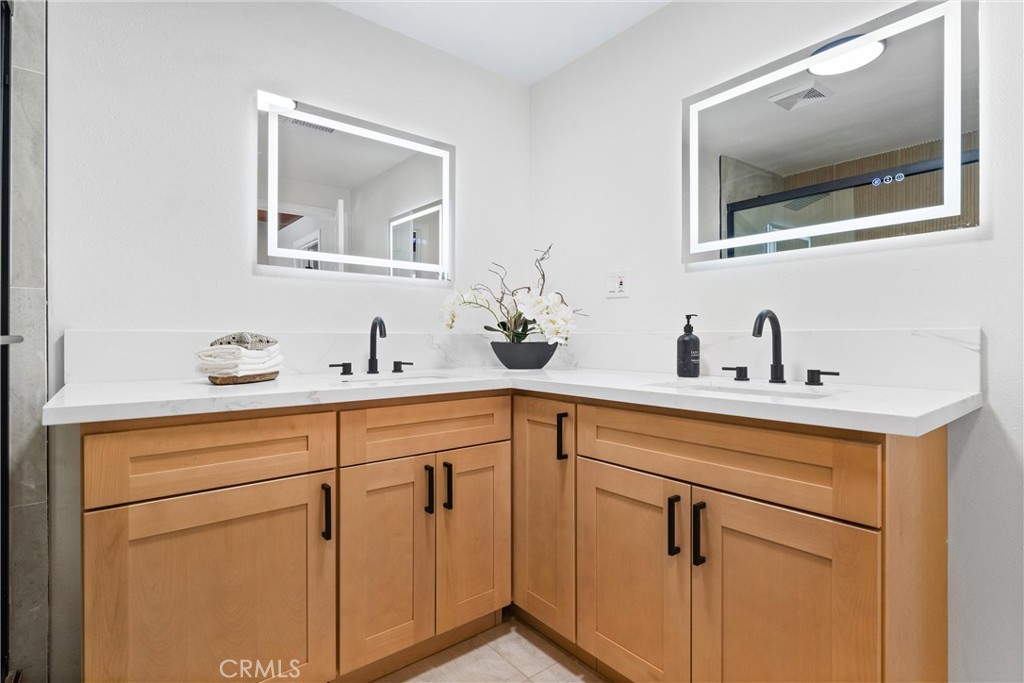 8039 4th Street Downey, CA 90241 - Photo 15 of 26 a bathroom with a sink and a mirror
