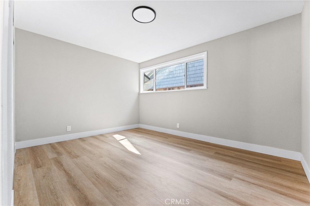 8039 4th Street Downey, CA 90241 - Photo 18 of 26 an empty room with wooden floor and windows