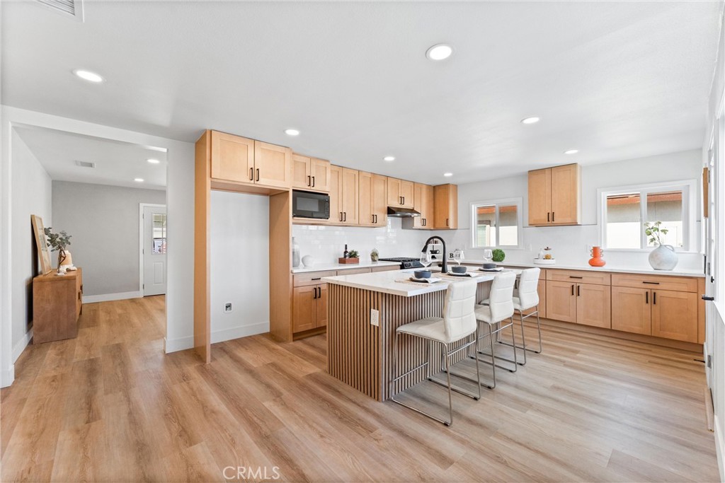 8039 4th Street Downey, CA 90241 - Photo 5 of 26 a kitchen with a sink appliances and cabinets