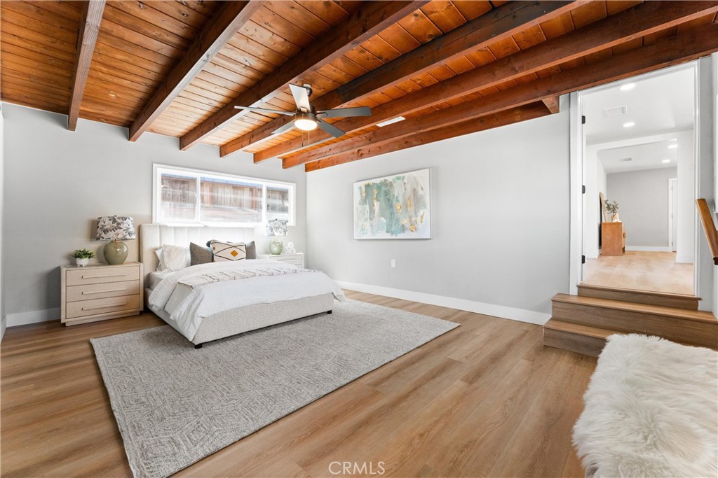 8039 4th Street Downey, CA 90241 - Photo 10 of 26 a bedroom with a large bed and a couch