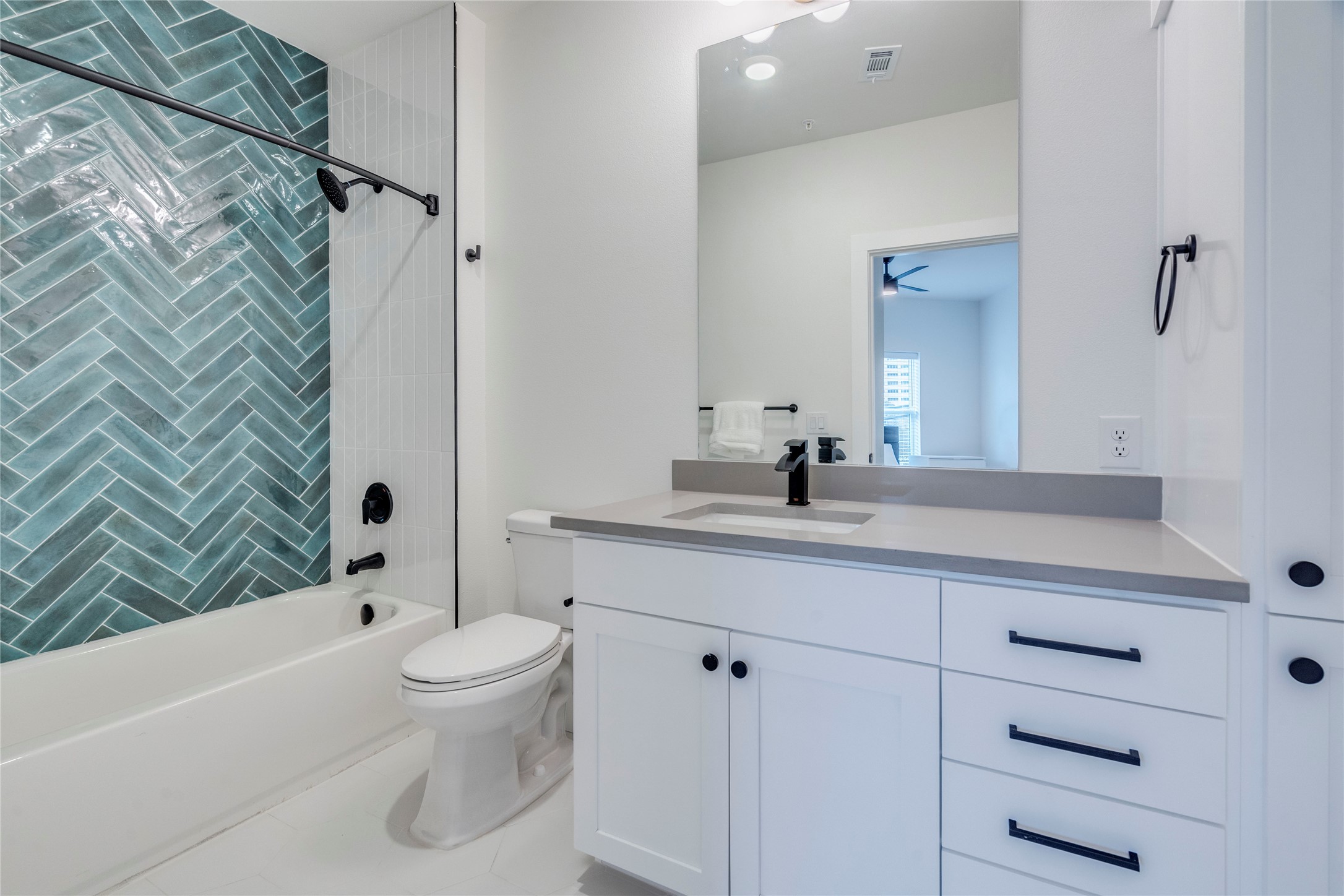 3000 Duval Street, Unit 207 Austin, TX 78705 - Photo 11 of 34 a bathroom with a granite countertop sink a toilet and a bathtub