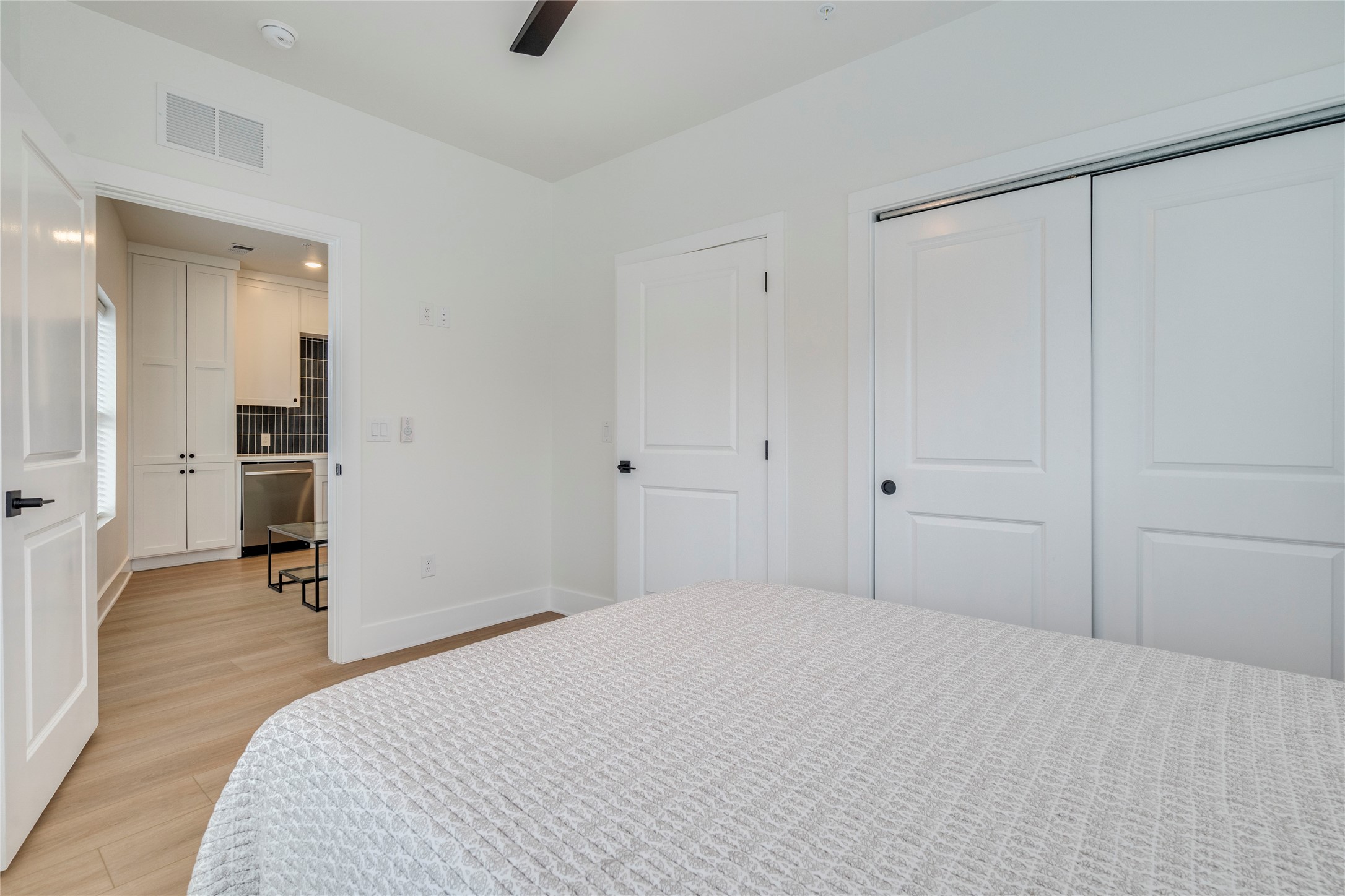 3000 Duval Street, Unit 207 Austin, TX 78705 - Photo 13 of 34 a bedroom with a bed and cabinets