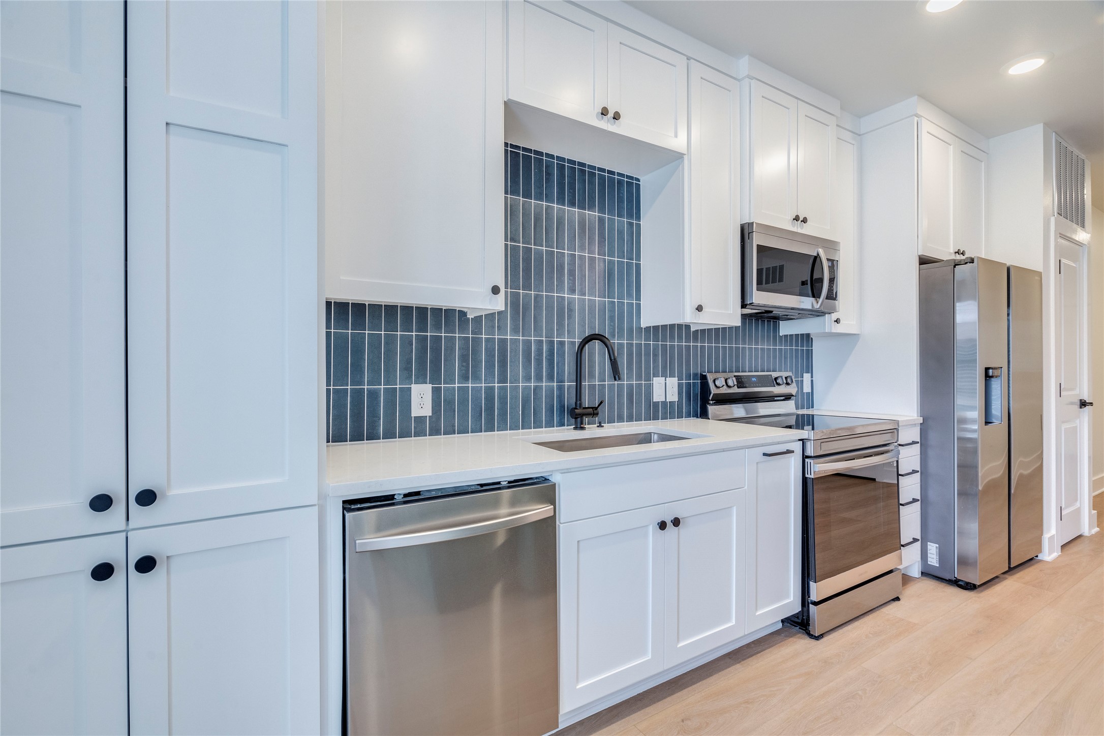 3000 Duval Street, Unit 207 Austin, TX 78705 - Photo 3 of 34 a kitchen with cabinets stainless steel appliances and a sink