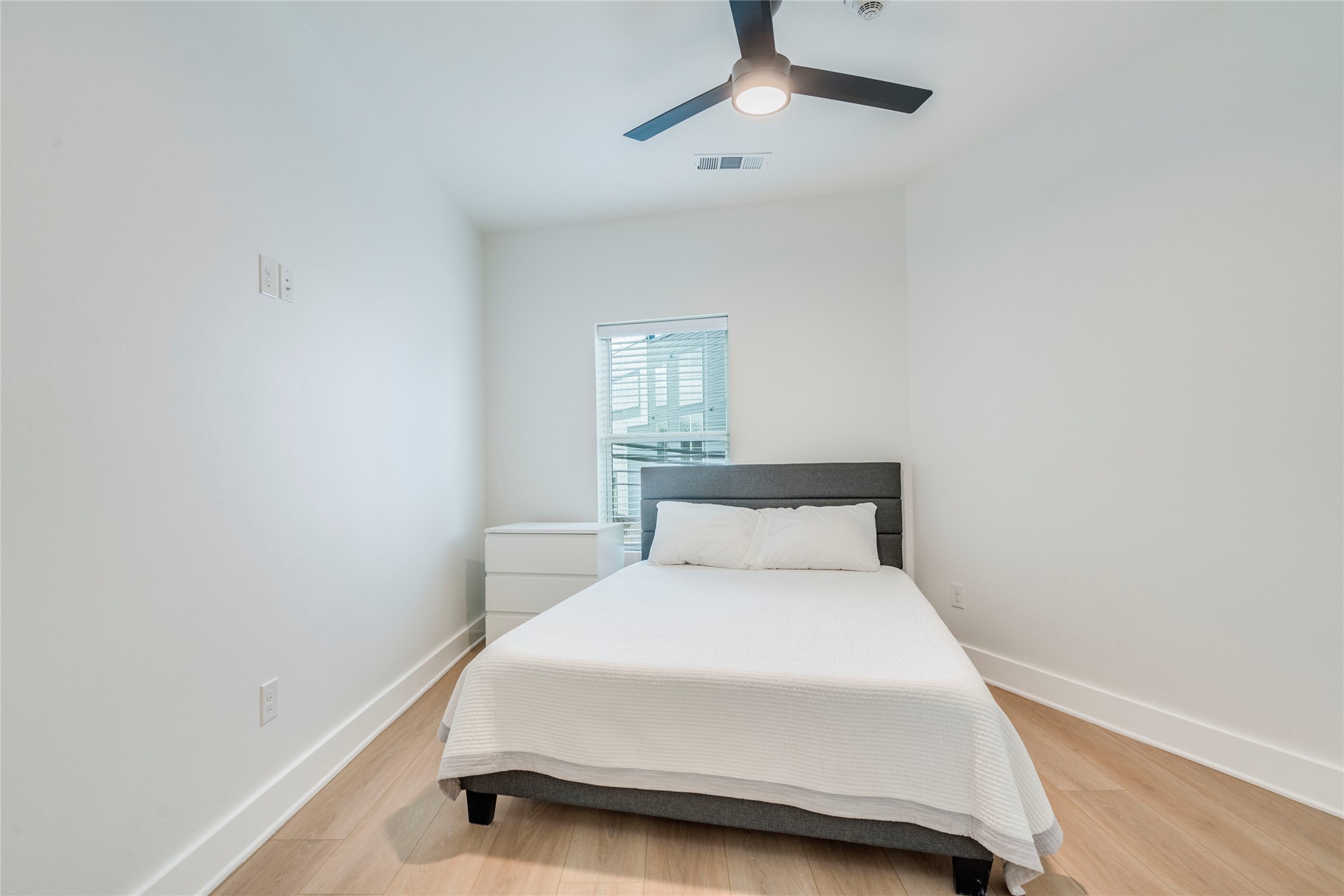 3000 Duval Street, Unit 207 Austin, TX 78705 - Photo 9 of 34 a bedroom with a bed and a ceiling fan