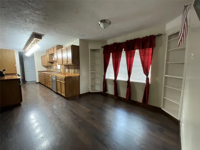 a view of kitchen with furniture wooden floor and kitchen