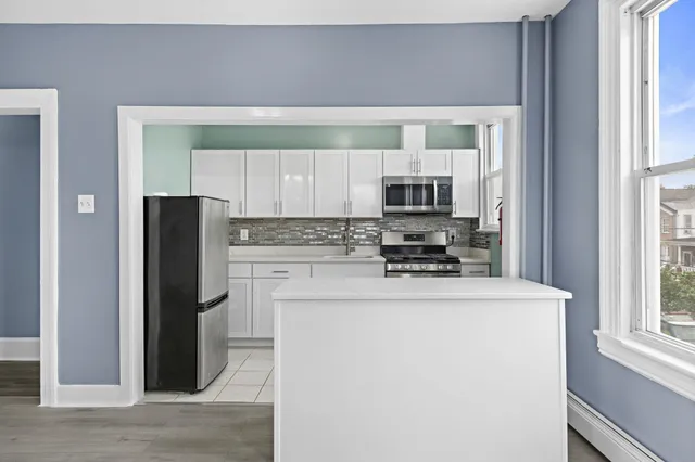 a kitchen with a refrigerator and a stove