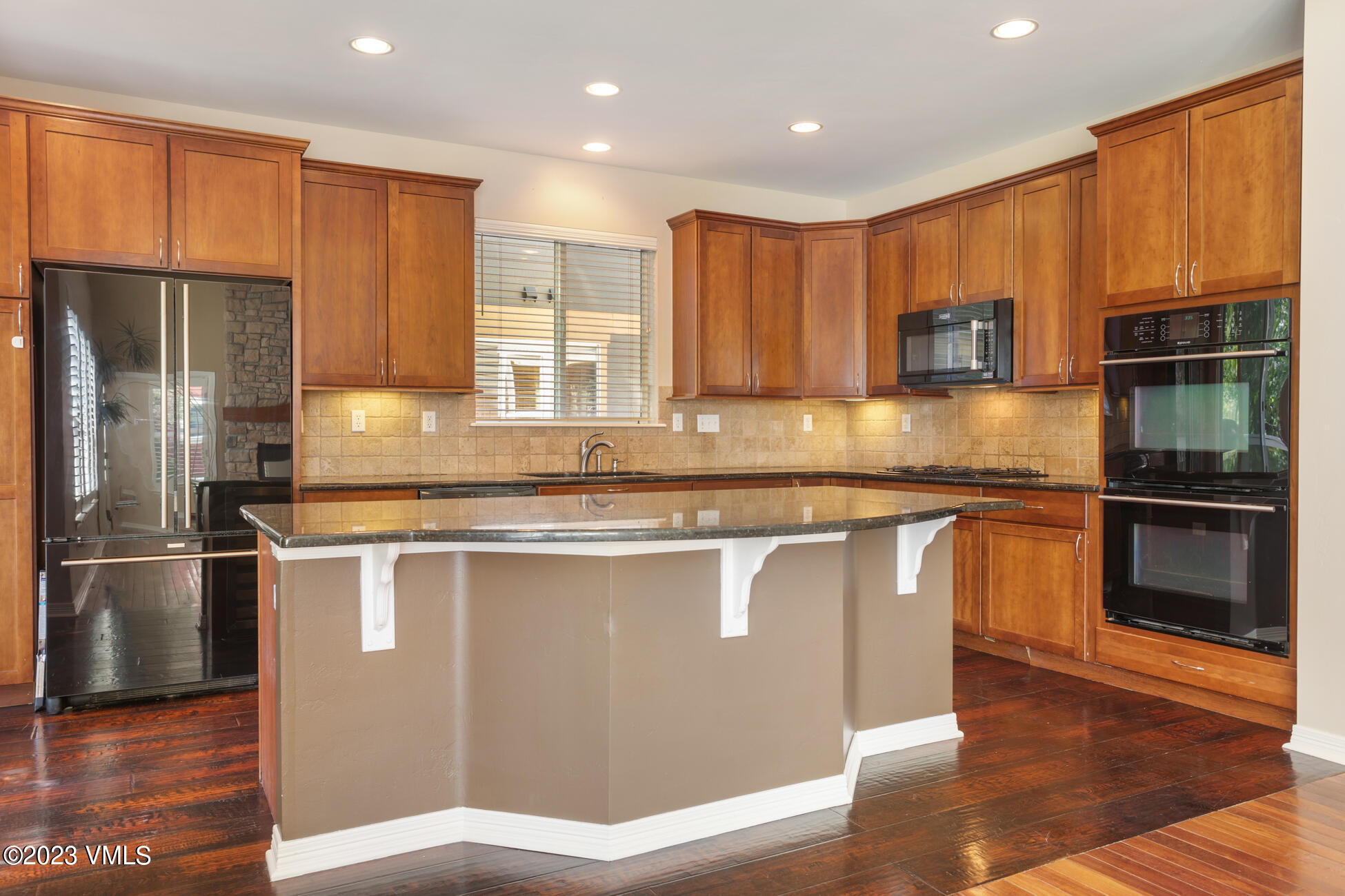 34 Greenhorn Avenue Eagle, CO 81631 - Photo 11 of 53 a kitchen with stainless steel appliances granite countertop a refrigerator a stove a sink and a microwave