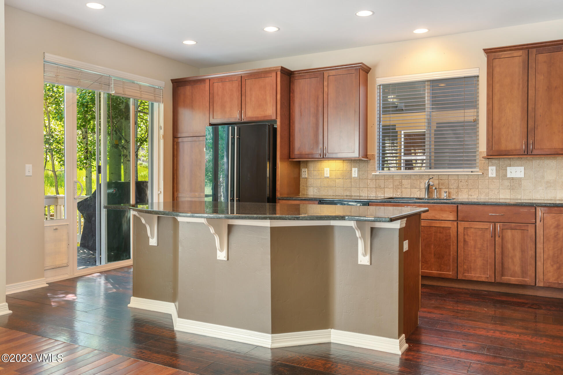 34 Greenhorn Avenue Eagle, CO 81631 - Photo 13 of 53 a kitchen with stainless steel appliances granite countertop a refrigerator a sink a stove a microwave and wooden cabinets