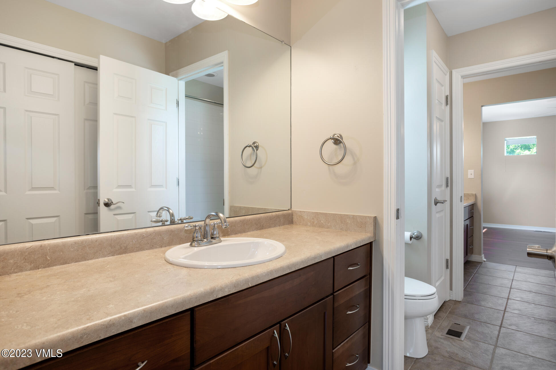 34 Greenhorn Avenue Eagle, CO 81631 - Photo 33 of 53 a bathroom with a granite countertop sink a toilet and a large mirror