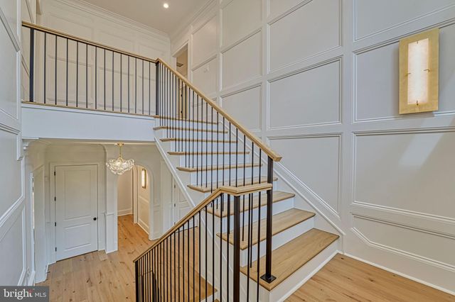 a view of empty room with wooden floor and fireplace