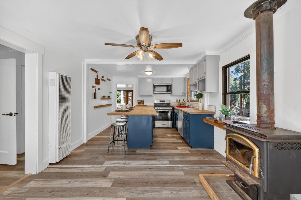2925 Maple Avenue Pollock Pines, CA 95726 - Photo 19 of 42 a open kitchen with stainless steel appliances granite countertop a stove top oven a sink dishwasher and a dining table with wooden floor