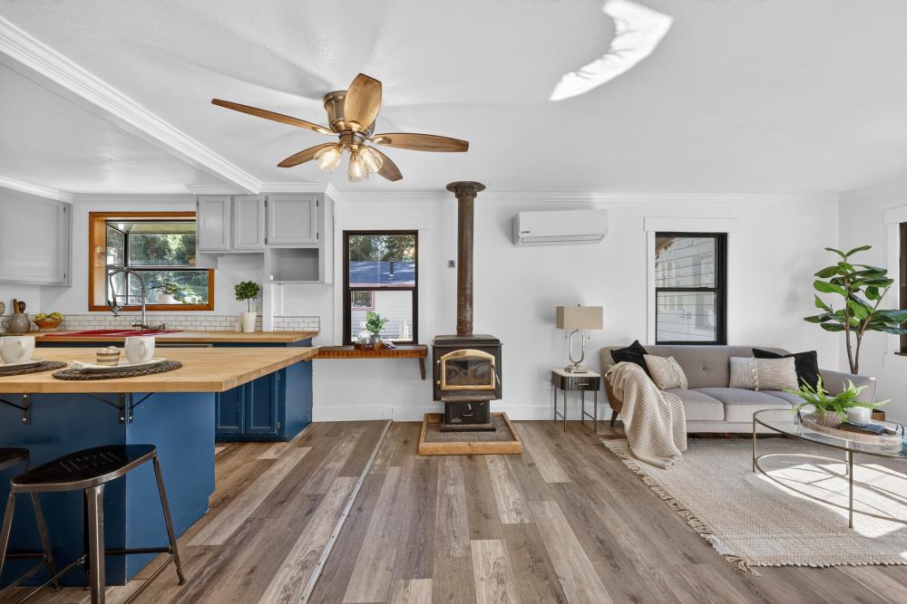 2925 Maple Avenue Pollock Pines, CA 95726 - Photo 5 of 42 a living room with furniture a dining table and paintings on the wall with wooden floor
