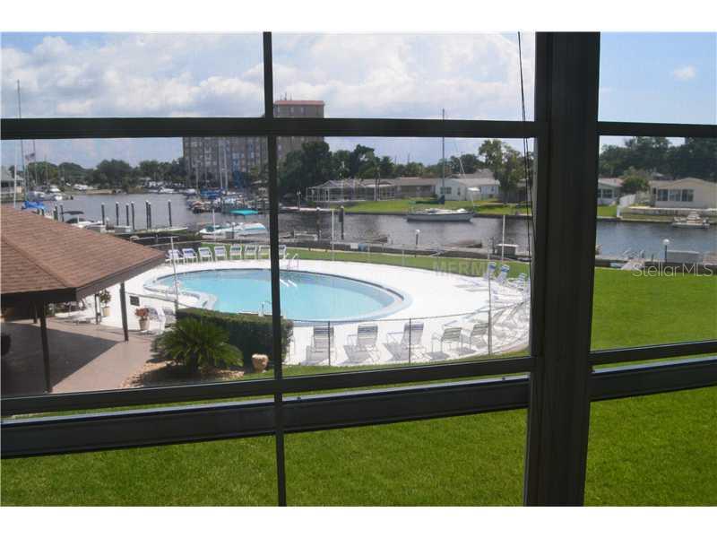 5157 Silent Loop, Unit 214 New Port Richey, FL 34652 - Photo 1 of 1 View - Lovely water and pool views from this 2nd floor condo. No age restrictions but perfect for retiree. The building has an elevator and trash chute.