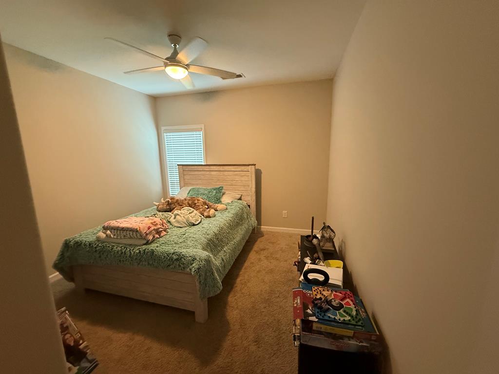 57 Hart Ridge Court Fortson, GA 31808 - Photo 11 of 38 a bedroom with a bed and a chandelier