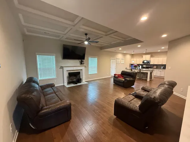 a living room with furniture fireplace and flat screen tv