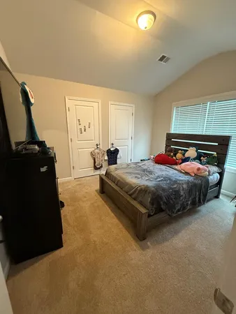 a bedroom with a bed and window