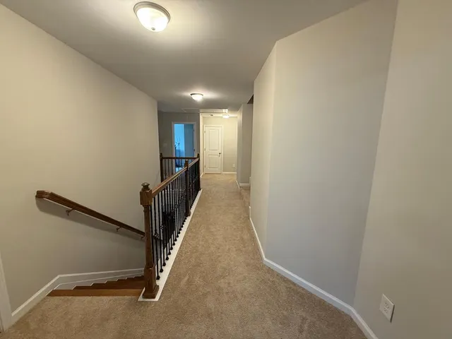 a view of a hallway with stairs