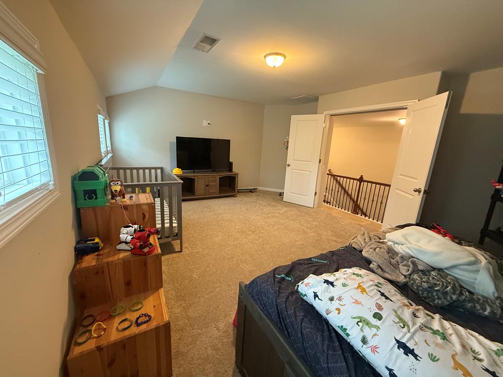 57 Hart Ridge Court Fortson, GA 31808 - Photo 20 of 38 a bedroom with a bed and a flat tv screen on the dresser
