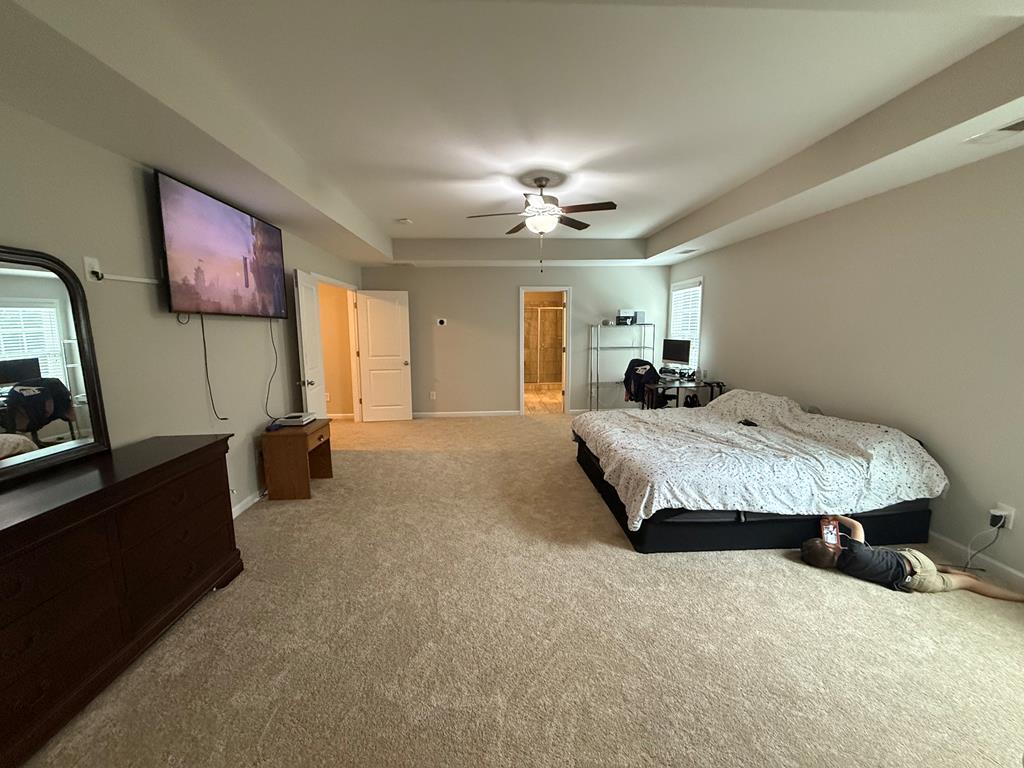 57 Hart Ridge Court Fortson, GA 31808 - Photo 25 of 38 a spacious bedroom with a bed and a flat screen television