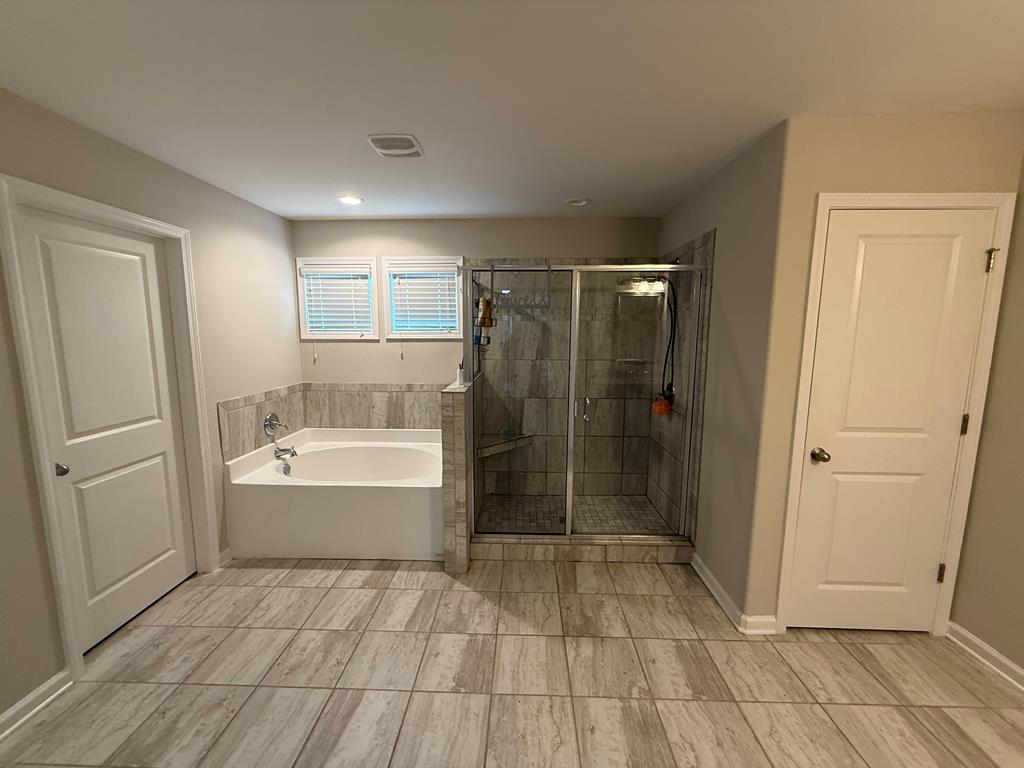 57 Hart Ridge Court Fortson, GA 31808 - Photo 28 of 38 a bathroom with a bathtub and a shower