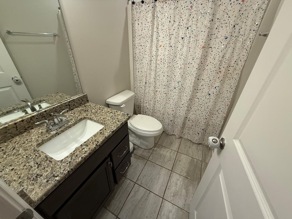 57 Hart Ridge Court Fortson, GA 31808 - Photo 34 of 38 a bathroom with a granite countertop sink toilet and shower