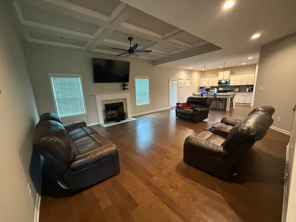 a living room with furniture a fireplace and a flat screen tv