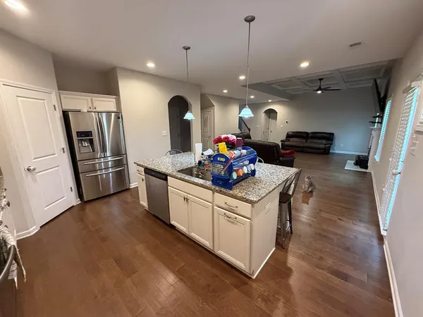 a kitchen with stove and refrigerator