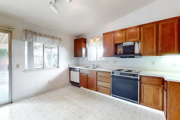 a kitchen with stainless steel appliances granite countertop a refrigerator and a sink