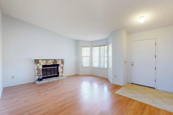an empty room with a hardwood and a window
