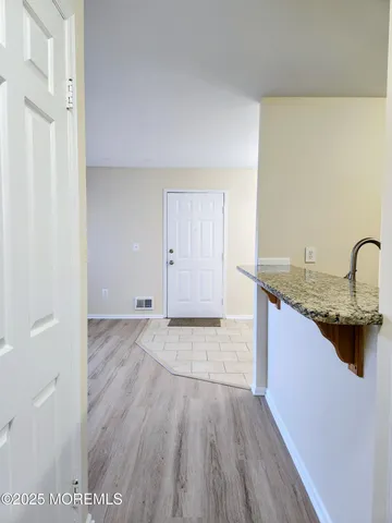 a view of a kitchen cabinets a sink and wooden floor