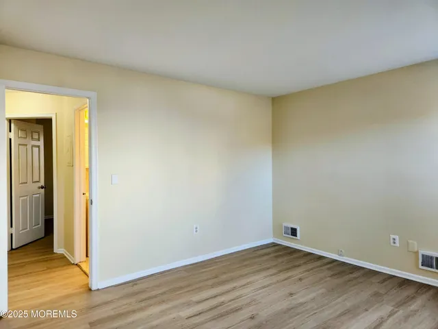 a view of an empty room and wooden floor