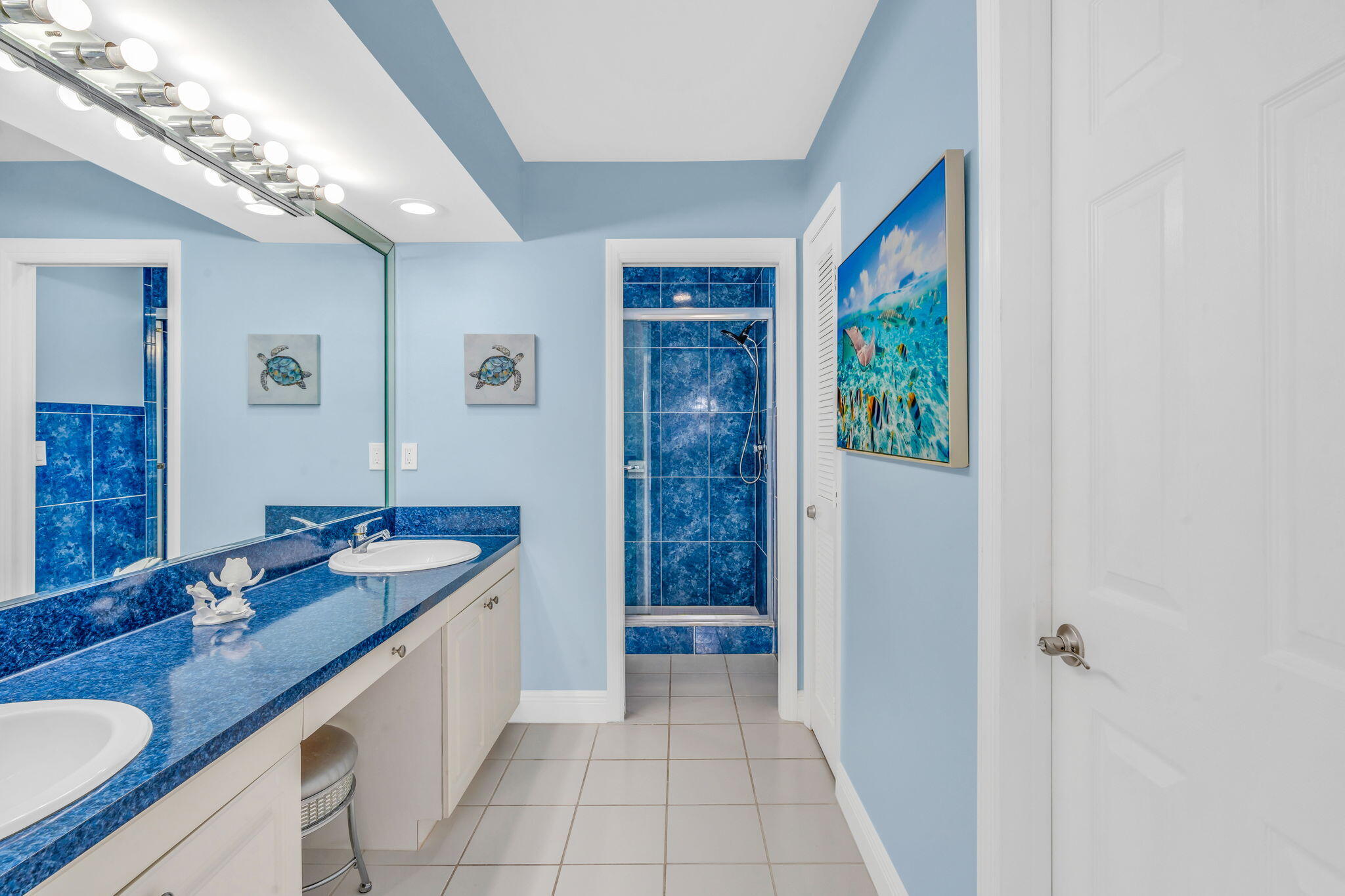 33 Kyle Way West Marathon, FL 33050 - Photo 19 of 44 a spacious bathroom with a granite countertop sink a mirror and a shower