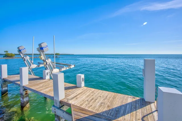 a open kitchen with white cabinets and stainless steel appliances