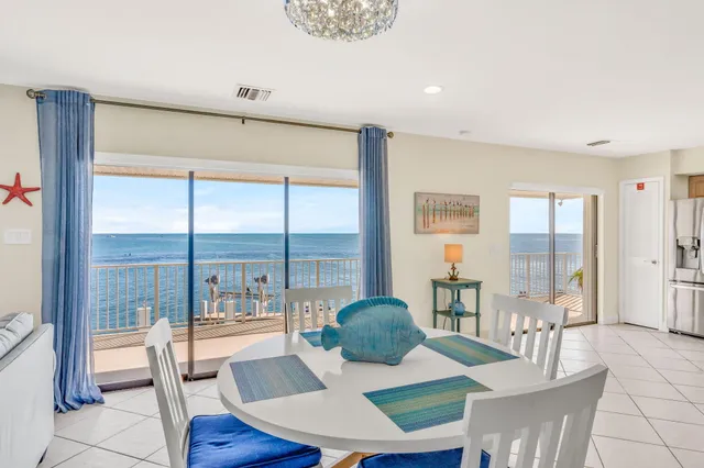a bedroom with a bed and a flat tv screen on dresser