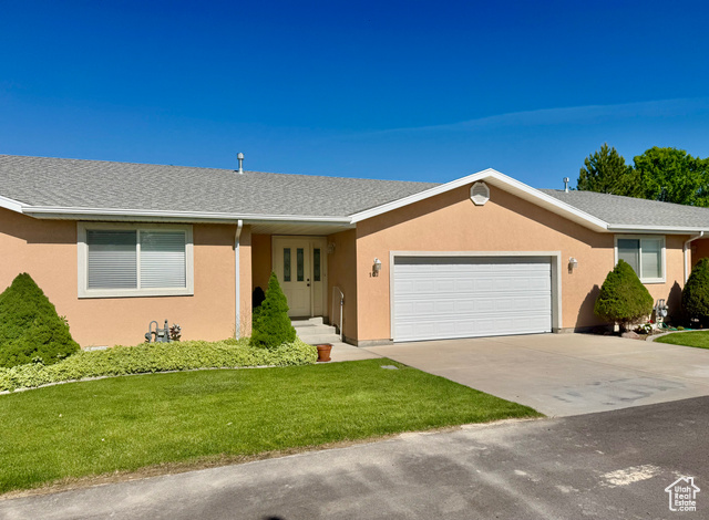 445 Topaz Boulevard, Unit 10 Delta, UT 84624 - Photo 26 of 28 Ranch-style house with a front lawn, a garage, and stucco siding