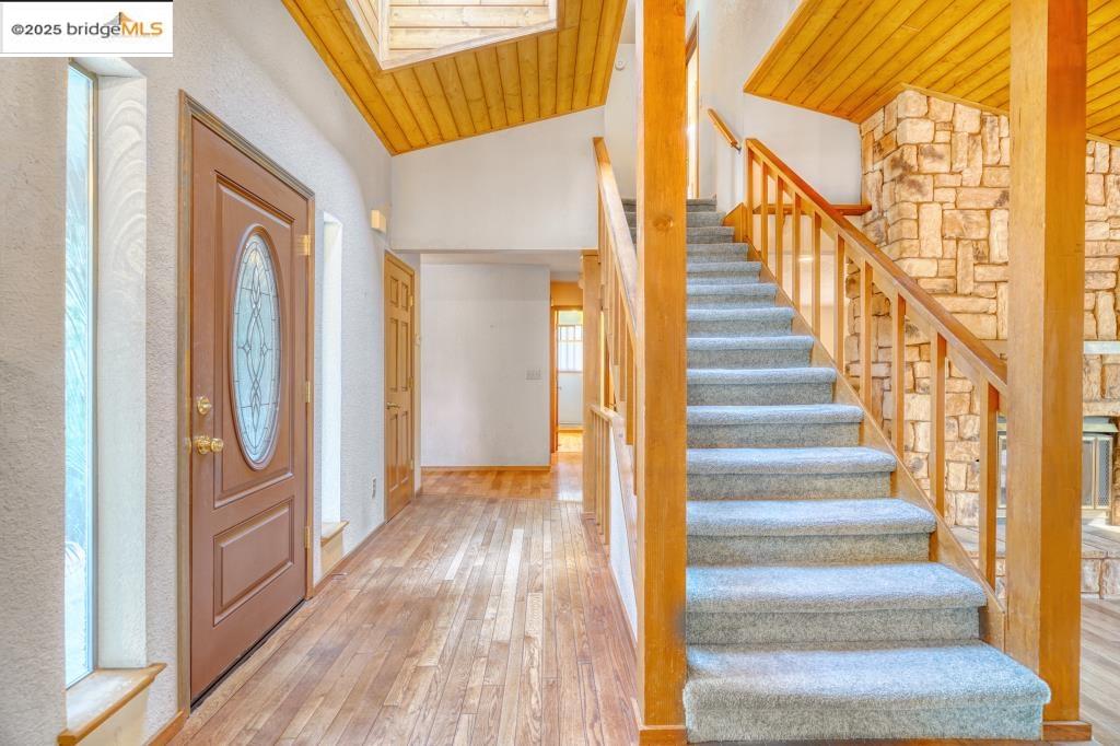 19195 Ferretti Road Groveland, CA 95321 - Photo 5 of 51 Entrance foyer with wood ceiling, light wood-type flooring, stairs, a skylight, and high vaulted ceiling