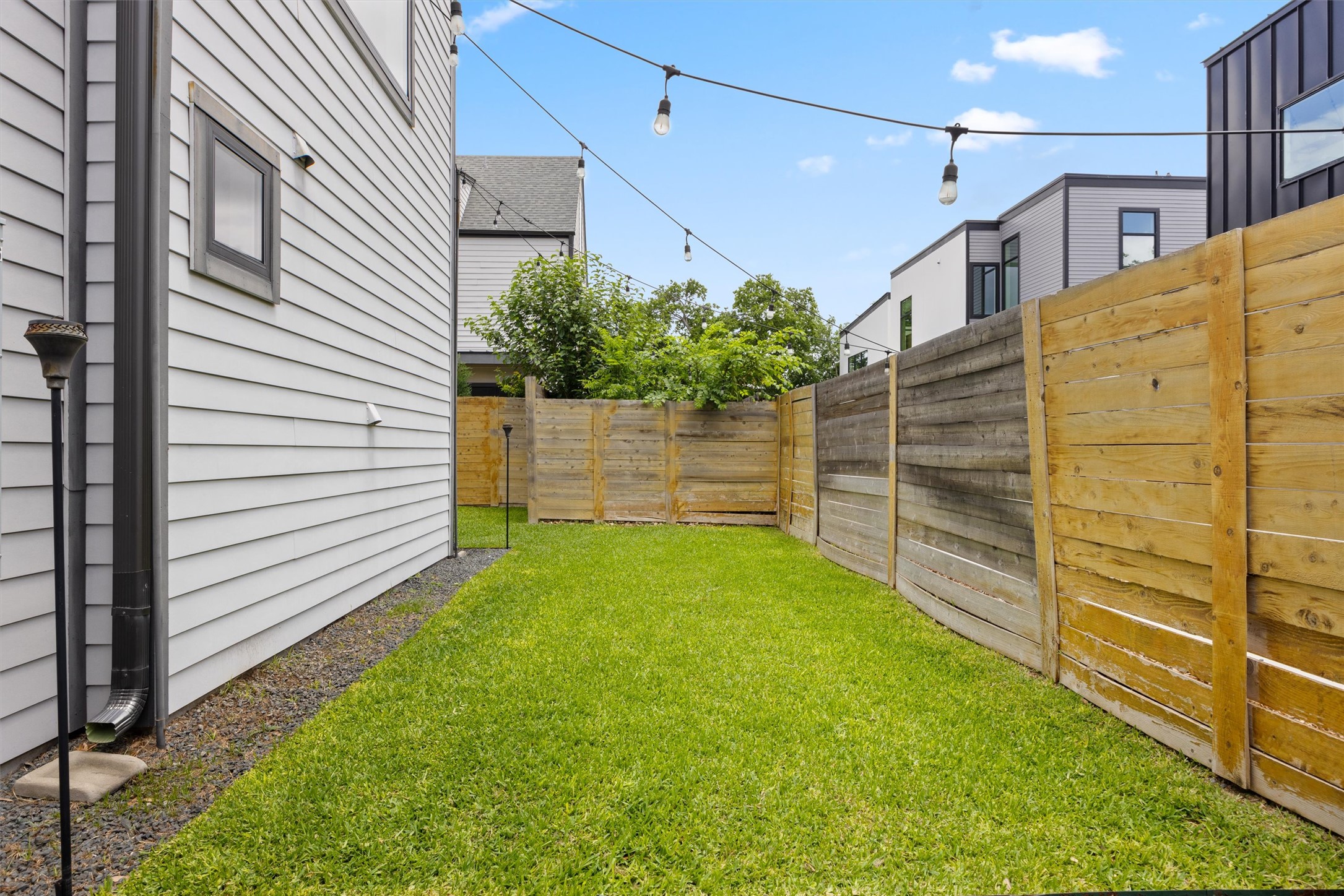 1116 Stobaugh Street, Unit B Austin, TX 78757 - Photo 34 of 38 The flat grassy yard provides usable outdoor space without excessive upkeep.
