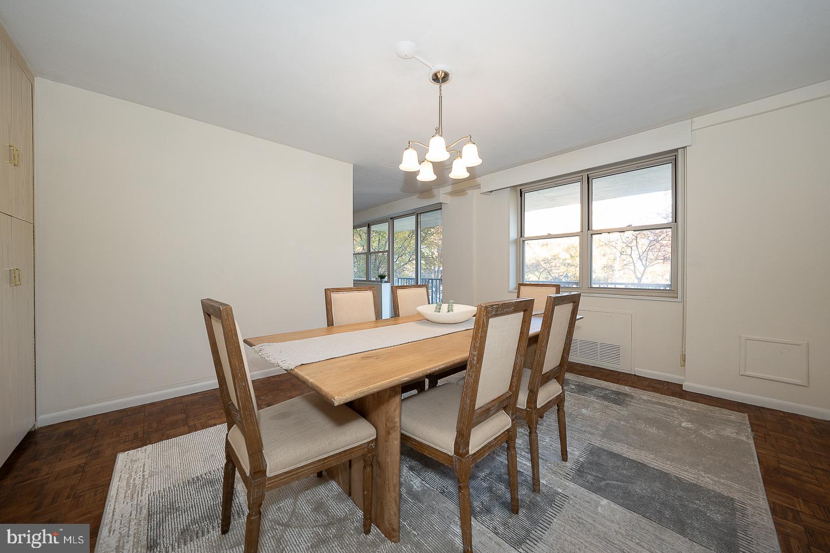 20 Conshohocken State Road, Unit 203 Bala Cynwyd, PA 19004 - Photo 11 of 35 a dining room with furniture a chandelier and wooden floor