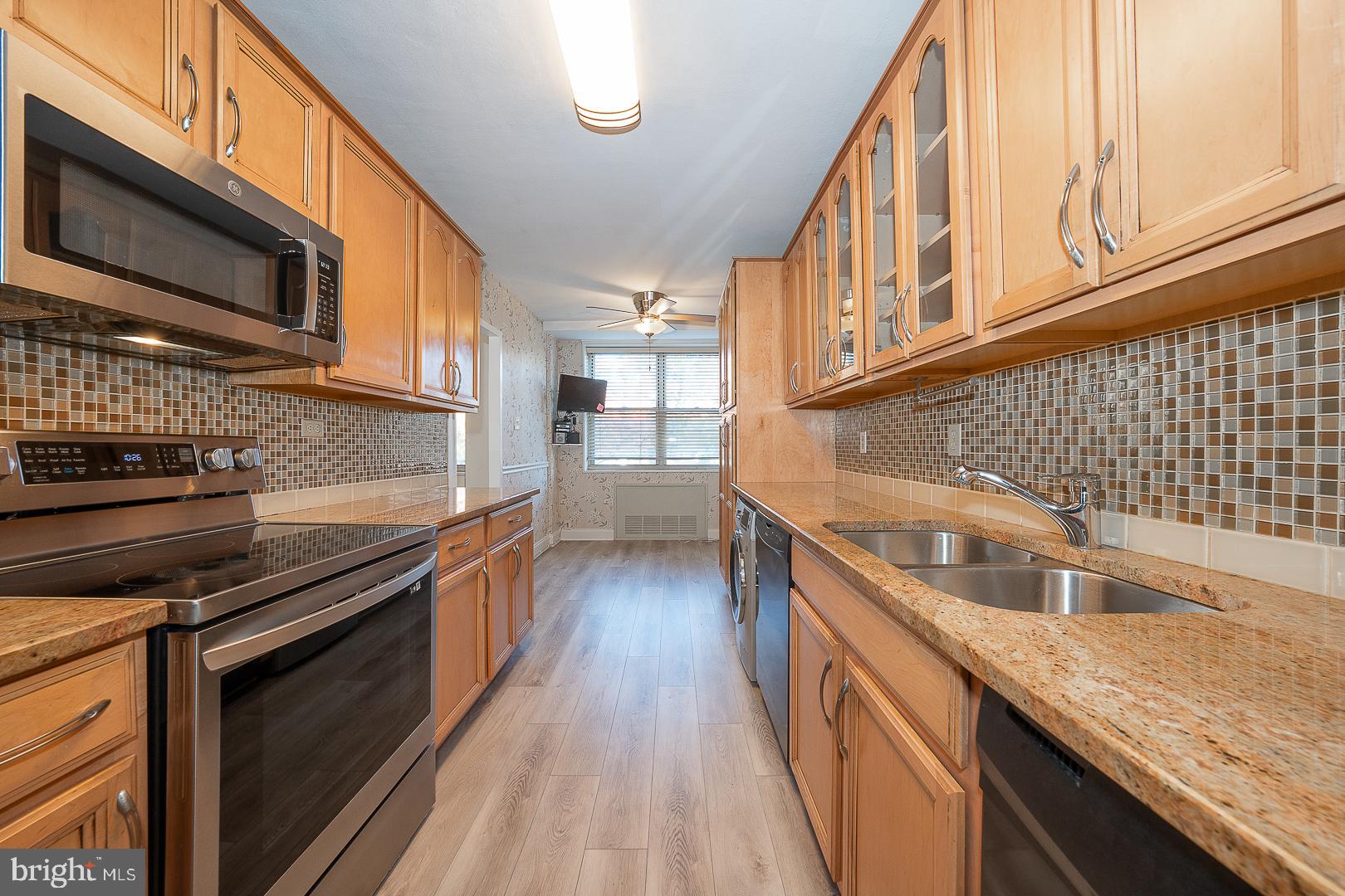 20 Conshohocken State Road, Unit 203 Bala Cynwyd, PA 19004 - Photo 12 of 35 a kitchen with stainless steel appliances granite countertop a sink a stove and microwave
