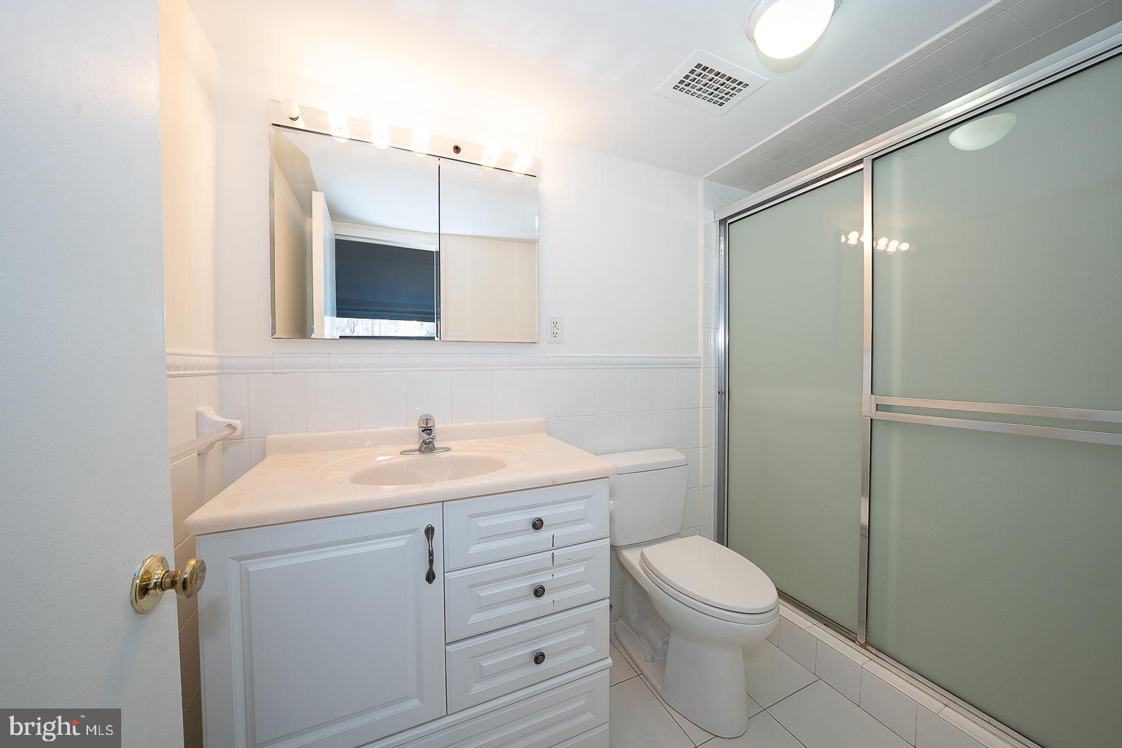 20 Conshohocken State Road, Unit 203 Bala Cynwyd, PA 19004 - Photo 22 of 35 a bathroom with a sink a toilet and shower