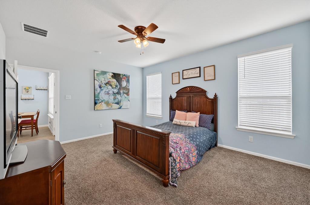 9604 Cherryville Road Fort Worth, TX 76108 - Photo 16 of 40 Carpeted room with light blue walls and a ceiling fan with integrated lighting