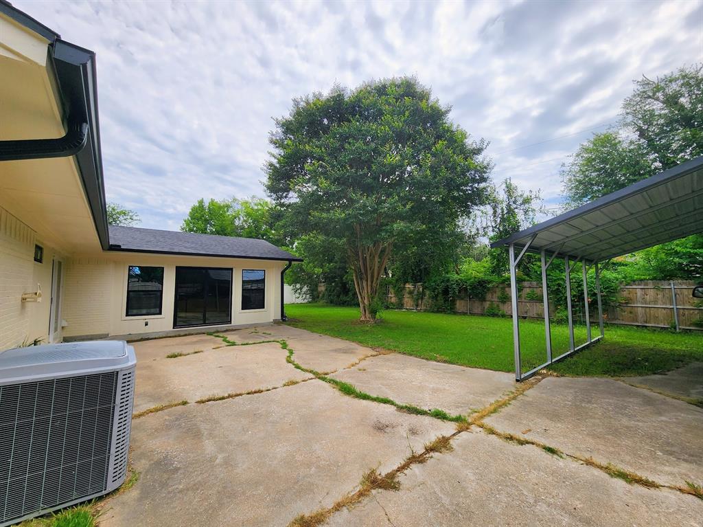 2908 Washington Street Commerce, TX 75428 - Photo 40 of 40 Expansive concrete patio area with a freestanding metal carport structure