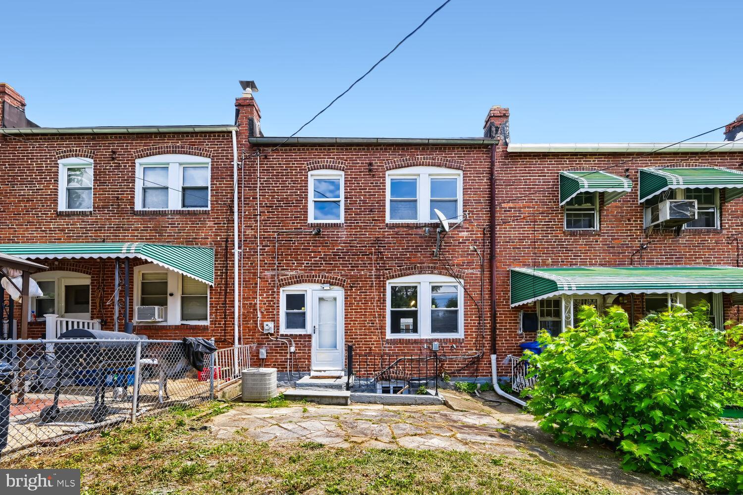 1014 Lyndhurst Street Baltimore, MD 21229 - Photo 28 of 29 a front view of a house with a yard